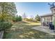 Backyard featuring lawn, patio, mature trees, and grill at 2441 Chatham Dr, Fort Mill, SC 29707