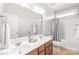 Bright bathroom featuring double sinks, a large mirror, and a shower-tub combination at 2441 Chatham Dr, Fort Mill, SC 29707