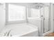 Bright bathroom with a garden tub under the window and a glass-enclosed shower at 2441 Chatham Dr, Fort Mill, SC 29707