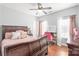 Bedroom with a large wood bed and decorative pillows, vanity with makeup mirror at 2441 Chatham Dr, Fort Mill, SC 29707