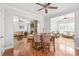 Open-concept dining area with hardwood floors and a view of the living room's stone fireplace at 2441 Chatham Dr, Fort Mill, SC 29707