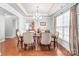Dining area featuring a chandelier, tray ceiling, and natural light through a large window at 2441 Chatham Dr, Fort Mill, SC 29707