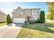 Charming two-story home featuring a stone facade, well-manicured lawn, and a two-car garage at 2441 Chatham Dr, Fort Mill, SC 29707