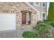 Inviting front entrance with stone archway, classic wood door, and landscaped greenery at 2441 Chatham Dr, Fort Mill, SC 29707