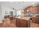 Open kitchen with wood cabinets, granite countertops, stainless appliances, and view into living area at 2441 Chatham Dr, Fort Mill, SC 29707
