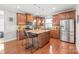 Spacious kitchen features a center island with bar seating, stainless steel appliances, and wooden cabinets at 2441 Chatham Dr, Fort Mill, SC 29707