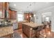 Stylish kitchen featuring stainless steel appliances, wood cabinets, and a central island with bar stools at 2441 Chatham Dr, Fort Mill, SC 29707