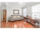Cozy living room with hardwood floors, tufted sofa, and natural light from windows at 2441 Chatham Dr, Fort Mill, SC 29707