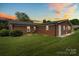 Brick home with a well-manicured lawn and a dark shingled roof at 301 Museum Rd, Statesville, NC 28625