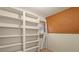 Unfinished basement featuring white built-in shelving and a brown pegboard wall at 301 Museum Rd, Statesville, NC 28625