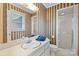 This bathroom features a shower, toilet, and vanity with wallpaper and a decorative mirror at 301 Museum Rd, Statesville, NC 28625