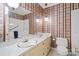 Bathroom features a double sink vanity, matching wallpaper and a bathtub at 301 Museum Rd, Statesville, NC 28625