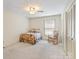 Cozy bedroom features a floral bedspread, rocking chair, and ample closet space at 301 Museum Rd, Statesville, NC 28625