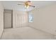 Bright bedroom with louvered closet doors and neutral colored carpet at 301 Museum Rd, Statesville, NC 28625