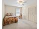 Bright bedroom with neutral carpet, ceiling fan, and closet with louvered doors at 301 Museum Rd, Statesville, NC 28625