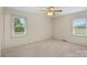 Spacious bedroom with plush carpet and plenty of natural light from two windows at 301 Museum Rd, Statesville, NC 28625