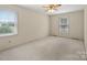 Large carpeted room with neutral walls and natural light coming through windows at 301 Museum Rd, Statesville, NC 28625