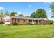 Beautifully landscaped brick home with a covered porch and a well-manicured lawn at 301 Museum Rd, Statesville, NC 28625