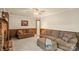 Comfortable living room with a brick fireplace, wood paneling and plush seating area at 301 Museum Rd, Statesville, NC 28625