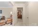 Bright living room featuring neutral walls, plush furniture, and an open doorway at 301 Museum Rd, Statesville, NC 28625
