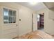 Mud room with tile flooring, door, and access to basement with brick wall and shelving at 301 Museum Rd, Statesville, NC 28625