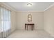 Cozy sitting room with neutral walls, carpet and a decorative mirror and side table at 301 Museum Rd, Statesville, NC 28625