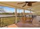 Relaxing back porch featuring a swing and scenic views of the serene lake at 3062 Bass Dr, Sherrills Ford, NC 28673