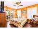 Cozy bedroom with wood-paneled walls, balcony access, and lake views at 3062 Bass Dr, Sherrills Ford, NC 28673