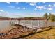 Picturesque dock featuring rope railing, an American flag, and tranquil lake views at 3062 Bass Dr, Sherrills Ford, NC 28673