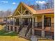 Charming exterior of the lake house with a metal roof, stone foundation, and inviting porch at 3062 Bass Dr, Sherrills Ford, NC 28673