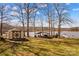Beautiful waterfront featuring a shed, covered seating area, and boat dock at 3062 Bass Dr, Sherrills Ford, NC 28673
