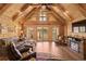 Vaulted great room boasts wood finishes, fireplace, and sliding glass doors to the balcony with lovely lake views at 3062 Bass Dr, Sherrills Ford, NC 28673