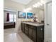 Bathroom with a double vanity featuring granite countertops, tile floors, and access to the main bedroom at 3537 Plum St, Fort Mill, SC 29715