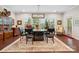 Elegant dining room with modern chandelier, large windows, hardwood floors, and classic furniture at 3537 Plum St, Fort Mill, SC 29715