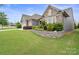 Beautifully landscaped front yard with stone accents and lush green lawn enhance the curb appeal at 3537 Plum St, Fort Mill, SC 29715