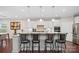 Stylish kitchen island with barstool seating, granite countertops, white cabinets, and stainless steel appliances at 3537 Plum St, Fort Mill, SC 29715