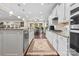 Bright kitchen featuring white cabinets, granite countertops, stainless steel appliances, and hardwood floors at 3537 Plum St, Fort Mill, SC 29715