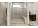 Modern bathroom featuring a glass-enclosed shower with bench seating and gray tiling at 3537 Plum St, Fort Mill, SC 29715
