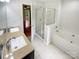 Bathroom featuring double sinks, tiled floors, separate tub and shower at 3600 Sipes Ln, Charlotte, NC 28269