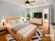 Tranquil bedroom with tray ceiling, hardwood floors, and ample natural light at 3600 Sipes Ln, Charlotte, NC 28269