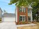 Charming two-story home featuring a brick facade, gray siding, and a two-car garage at 3600 Sipes Ln, Charlotte, NC 28269