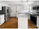 Kitchen featuring stainless steel appliances, an island, and hardwood floors at 3600 Sipes Ln, Charlotte, NC 28269