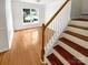 Bright living room featuring wood floors and staircase at 3600 Sipes Ln, Charlotte, NC 28269
