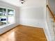 Bright living room with wood floors and staircase near a bright window at 3600 Sipes Ln, Charlotte, NC 28269