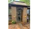 Building entrance with brick facade, glass doorway, unit number and globe lighting fixtures at 417 Orchard Trace Ln # 6, Charlotte, NC 28213