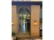 Building entrance with brick facade, glass doorway, unit number and globe lighting fixtures at 417 Orchard Trace Ln # 6, Charlotte, NC 28213