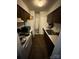 Galley kitchen with white appliances and wood cabinets at 417 Orchard Trace Ln # 6, Charlotte, NC 28213