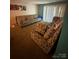 Living room with patterned sofa, carpeting and sliding glass door at 417 Orchard Trace Ln # 6, Charlotte, NC 28213