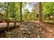 Natural rock drainage leading to backyard deck, blending nature with functional design at 46 Timberidge Dr, Lake Wylie, SC 29710