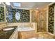 Stylish bathroom featuring double sinks, a garden tub, and a glass-enclosed shower at 46 Timberidge Dr, Lake Wylie, SC 29710